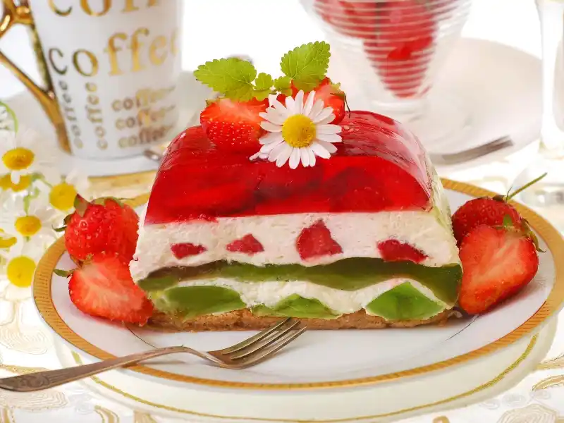 Strawberry kiwi cake in plate with fork