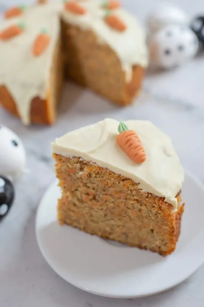 slice of moist carrot cake on a white plate