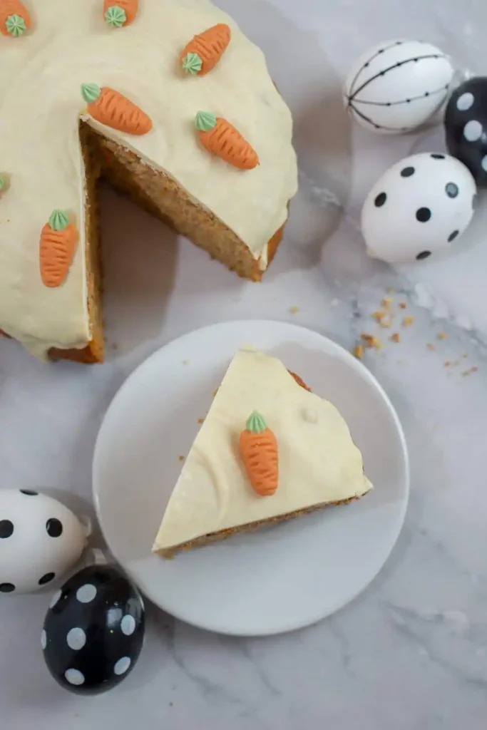 beautifully frosted carrot cake on a cake stand