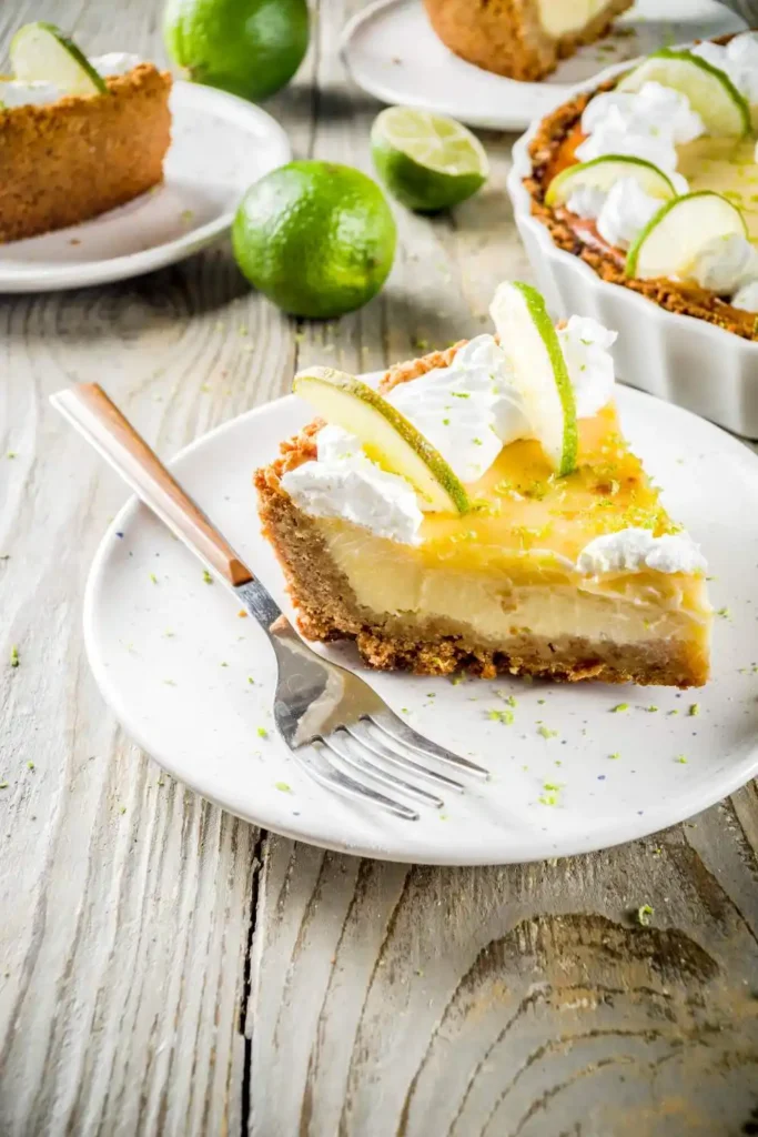 A perfectly sliced key lime pie on a white plate