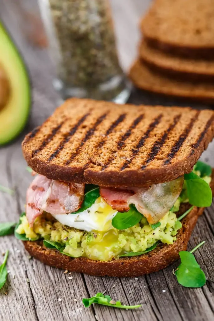 Bacon, Egg & Avocado Sandwich with crispy bacon, a perfectly cooked egg, and creamy avocado slices layered between toasted bread