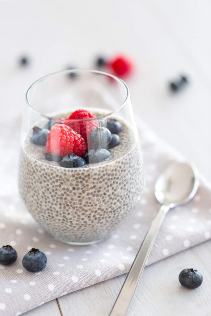 chia seed pudding with berries toppings ans spoon