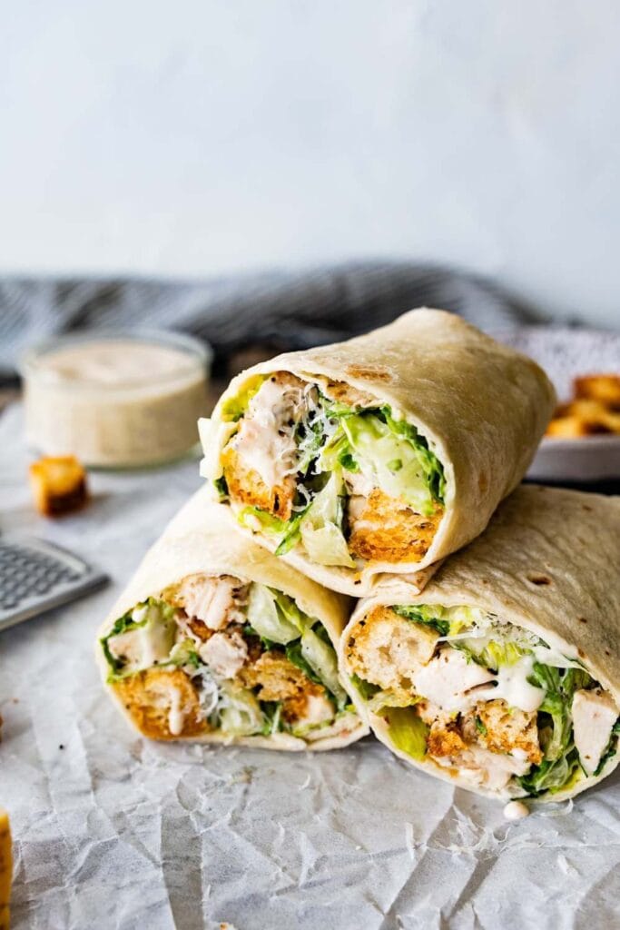 elicious wrap filled with grilled chicken, crisp romaine lettuce, Parmesan cheese, and Caesar dressing,