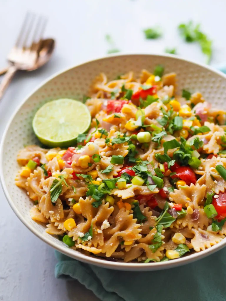 Herbed Summer Corn Pasta Salad in bowl with lemon