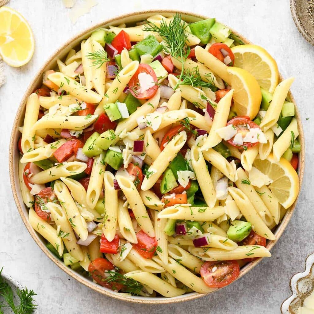 colorful Lemon Summer Pasta Salad in a white bowl