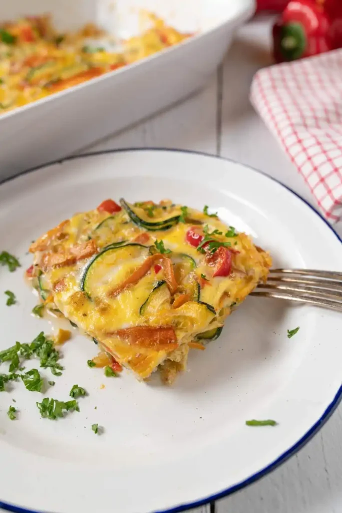 Zucchini Frittata with golden edges, topped with fresh herbs