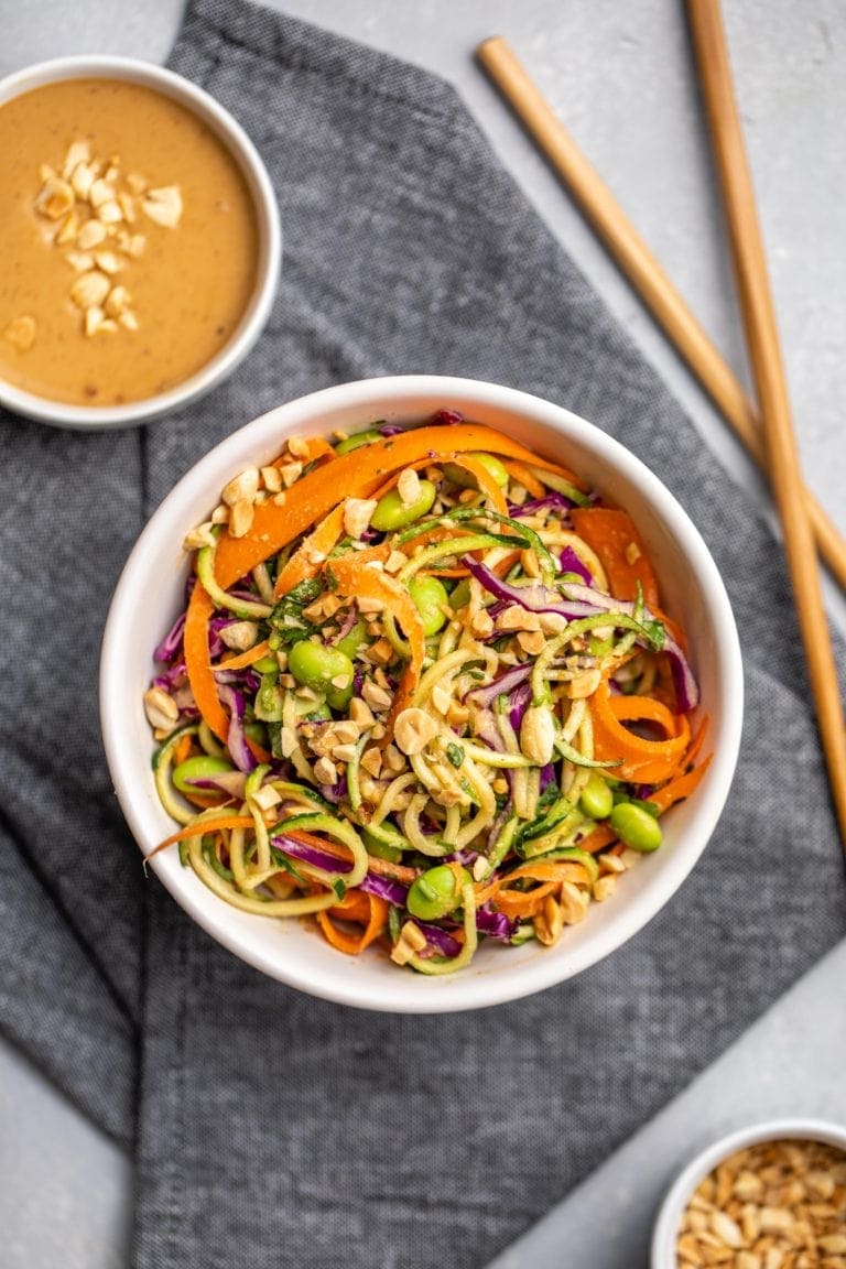 Colorful zucchini noodles tossed with crunchy vegetables and a creamy peanut sauce