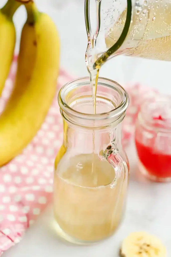 Pouring banana syrup in bottle