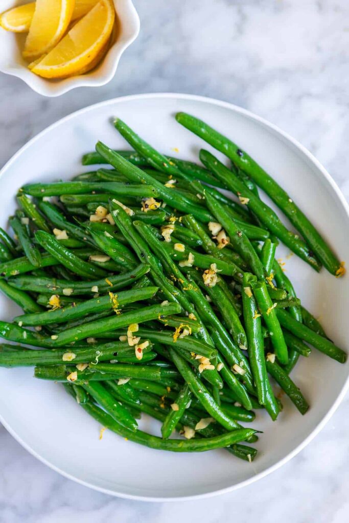 Garlic Butter Sauteed Green Beans in white plate