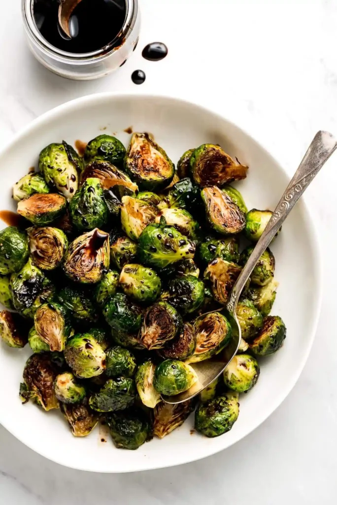 Roasted Brussels Sprouts with Balsamic Glaze in white plate