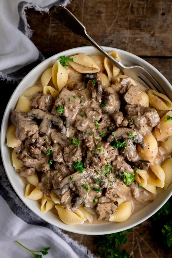 Slow Cooker Beef Stroganoff in white plate with fork