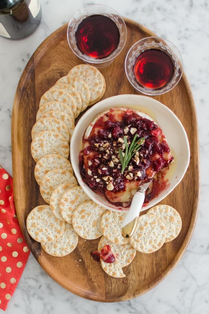 Baked-Brie-with-Cranberry-Sauce in wooden tray