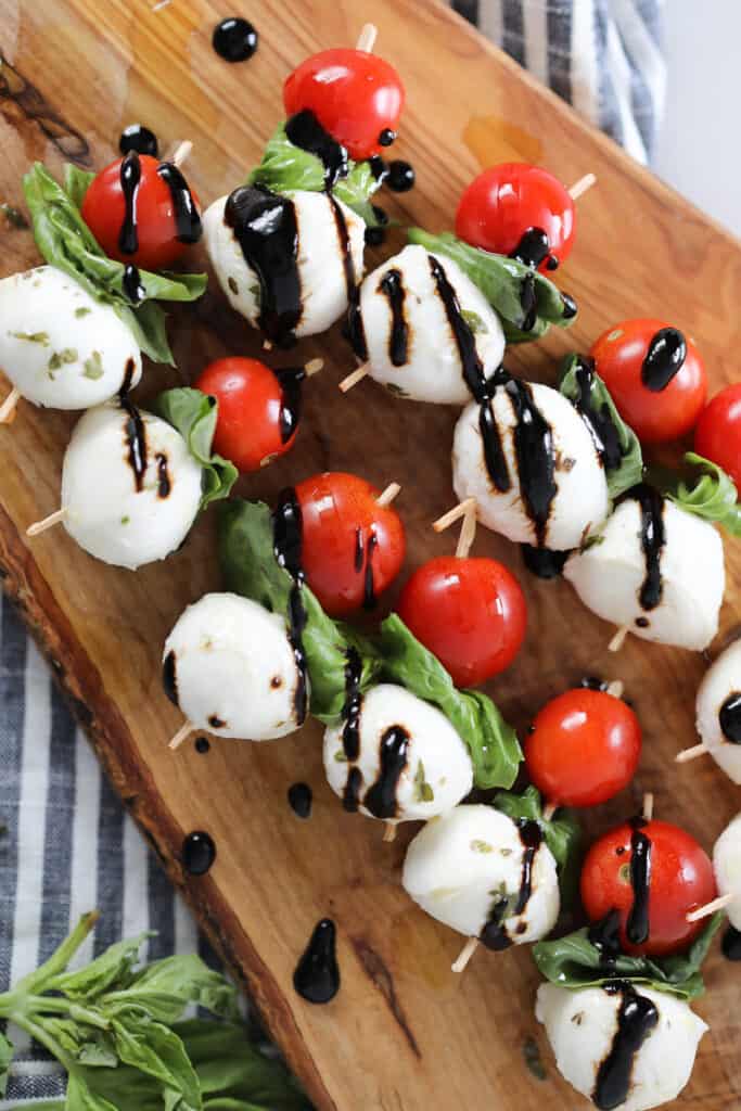 Mini Caprese Skewers arranged on wooden tray