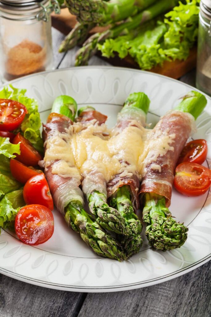 Prosciutto Wrapped Asparagus With Cream Cheese in white plate