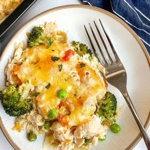 rectangular dish full with nixon chicken and a plate with casserole place nearby