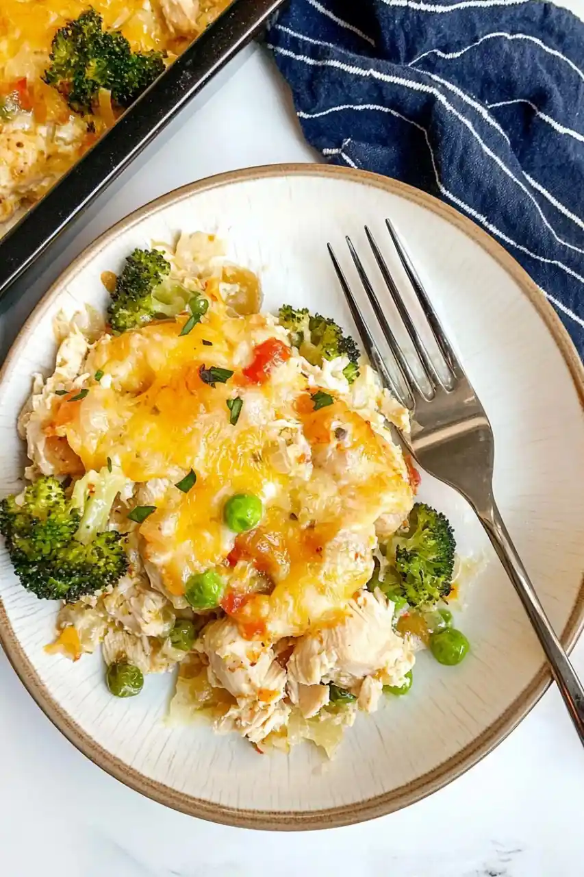 rectangular dish full with nixon chicken and a plate with casserole place nearby