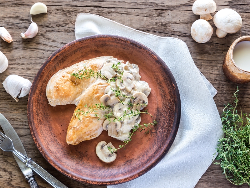 Lemon cream roasted chicken with mushrooms in plate 