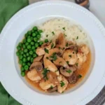 Chicken Marsala served with peas and rice