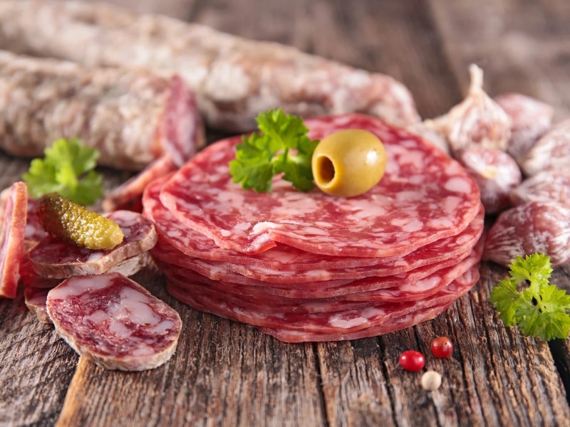 Salami in kitchen on wooden table