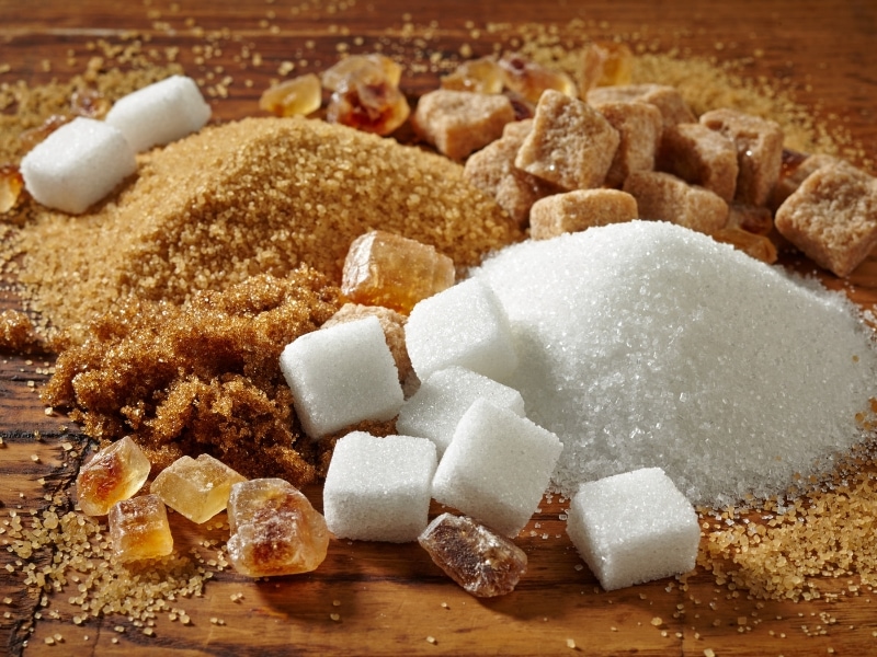 Different types of sugar on wooden table