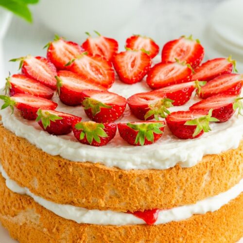 Strawberry Basil Cake with cream and strawberry frosting in plate