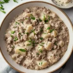 potato stroganoff in plate garnish with cheese