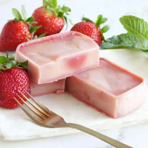 slices of strawberry mochi cake and fork place nearby