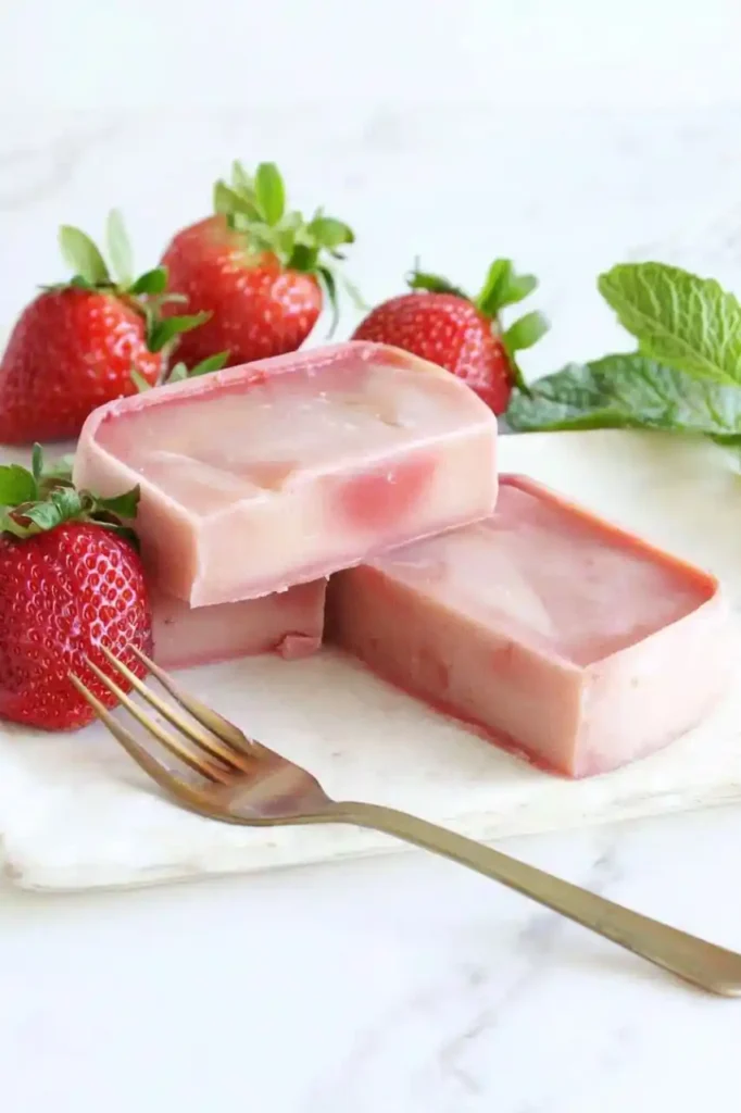slices of strawberry mochi cake and fork place nearby