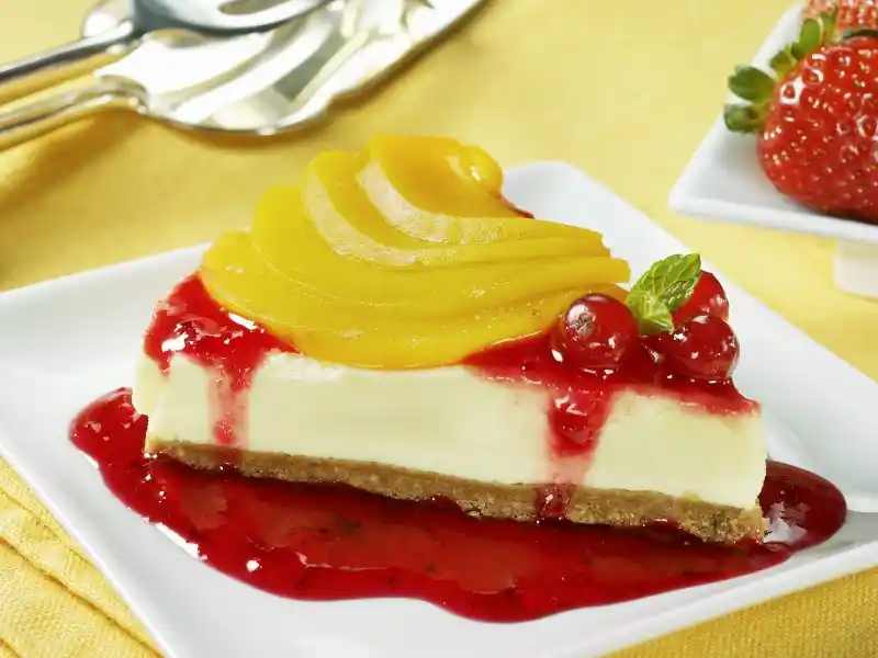 Strawberry Peach Cake in plate on table with spoon