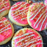 close view of Strawberry Shortcake Sugar Cookies decorated with cream