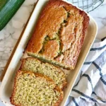 loaf of zucchini bread and two slices are cut from loaf