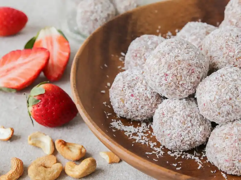 Strawberry coconut balls in wooden plate