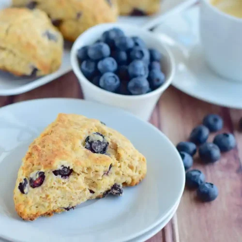 Freshly baked blueberry scones served with a cup of hot tea