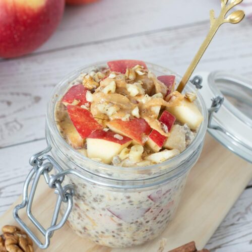 Apple Cinnamon Overnight Oats With Almond Milk in glass with wooden spoon