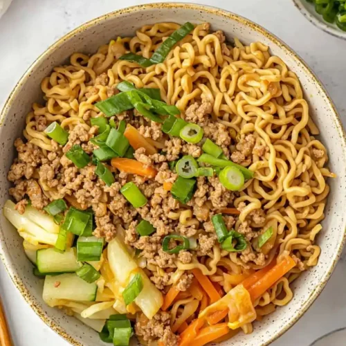 Ramen Noodles With Ground Beef And Vegetables in white bowl and nearby chopstick is place