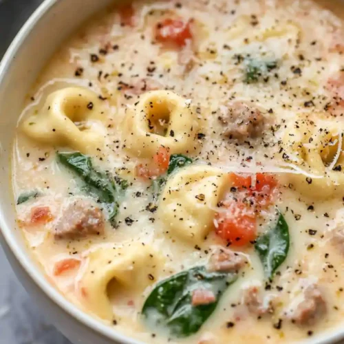 top view of crockpot tortellini soup with sausage and cream cheese in bowl